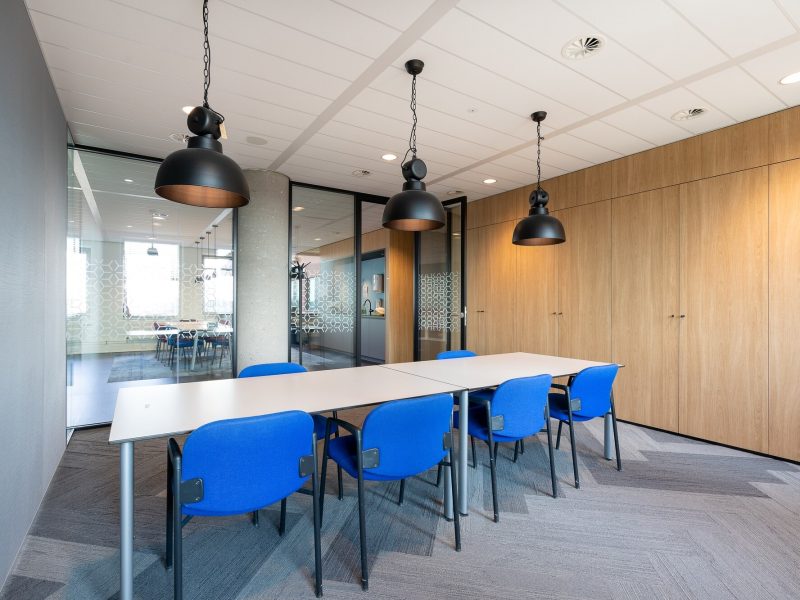 meeting-room-interior-modern-office-with-long-wooden-table-chairs-around-it_181624-21722